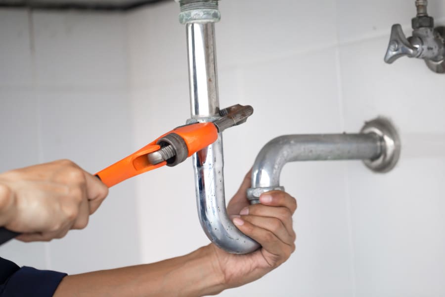 plumber at work in a bathroom, plumbing repair service, assemble and install concept.